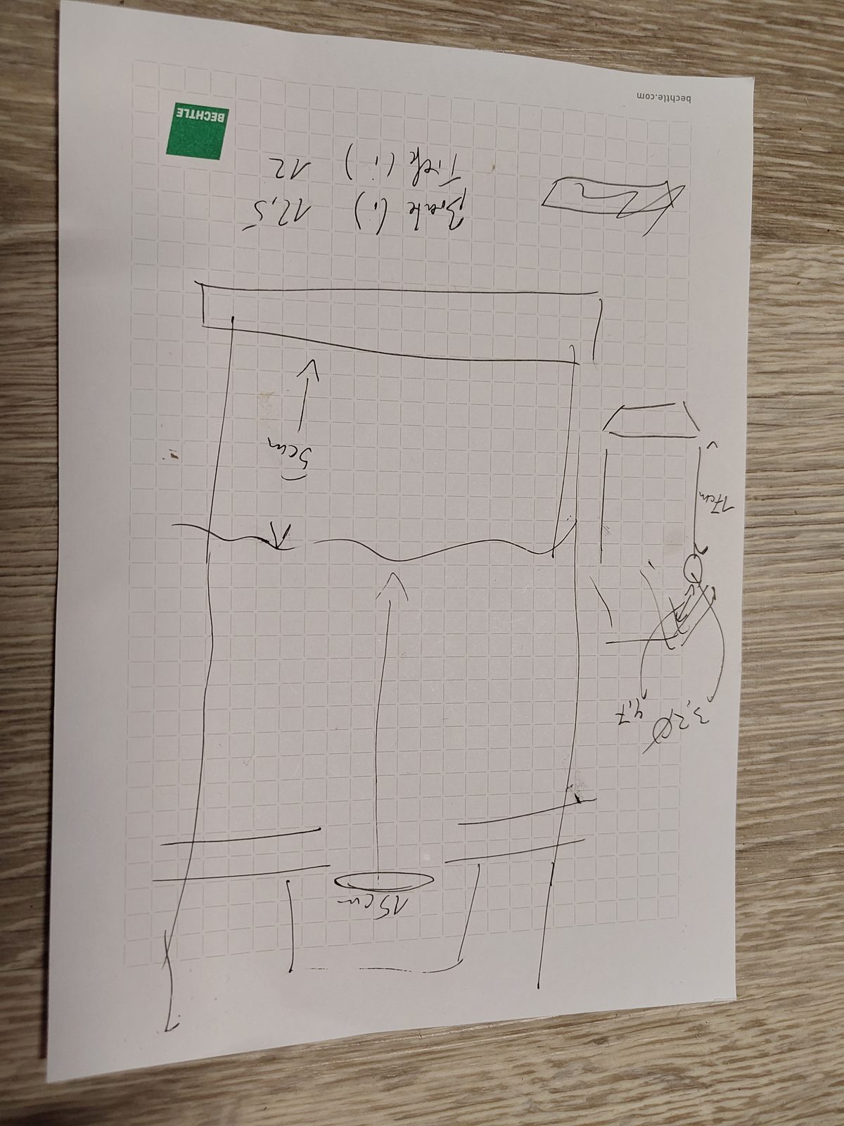 Hand-drawn sketch on squared paper, upside down: cross-section of the box with camera, nest height and entrance hole